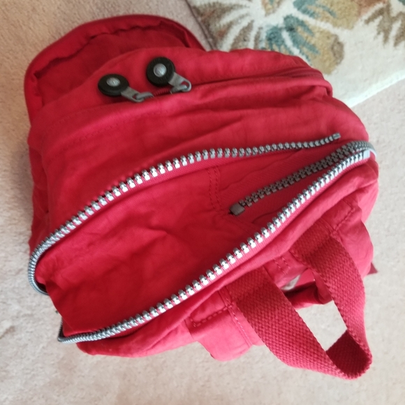Kipling size Adjustable backpack. No laptop pouch. Minor wear and tear.